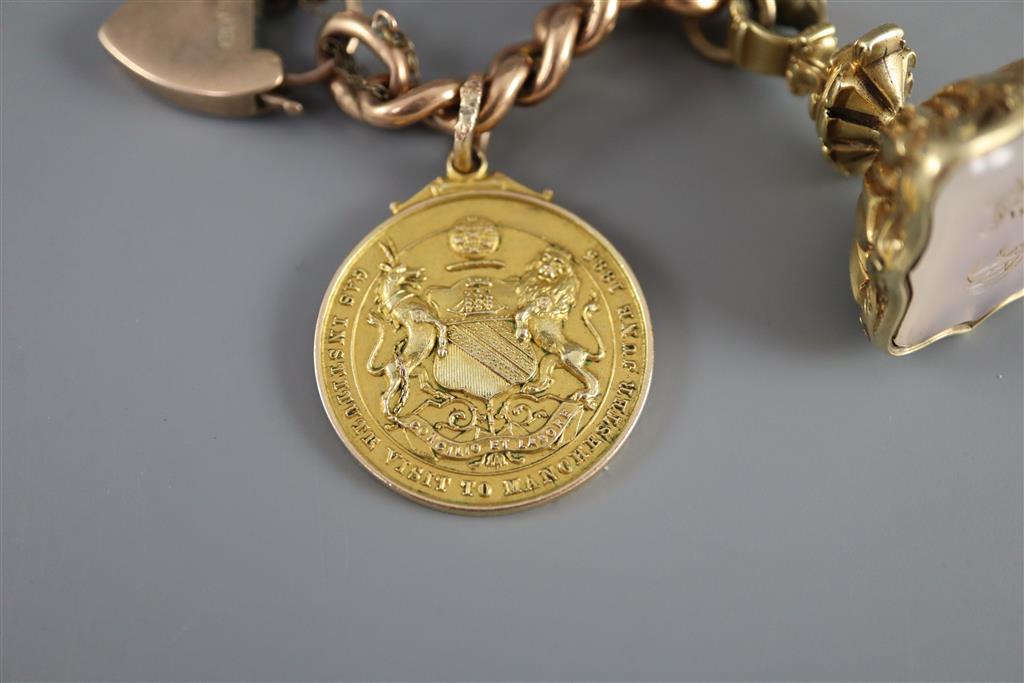 A late 19th/early 20th century 9ct gold curb link charm bracelet,